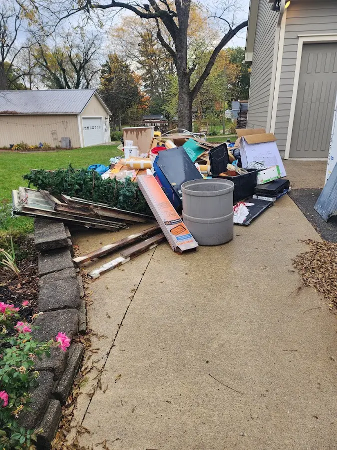 Dumpster being loaded with debris for Estate Cleanout Dumpster Rental in Colorado City